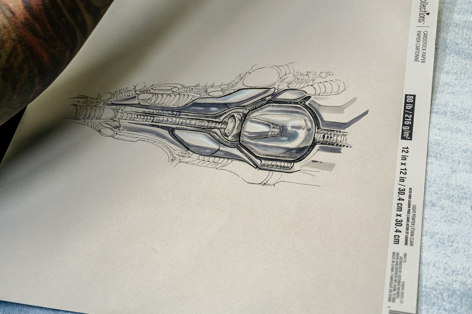 A detailed sketch of a mechanical object on paper.